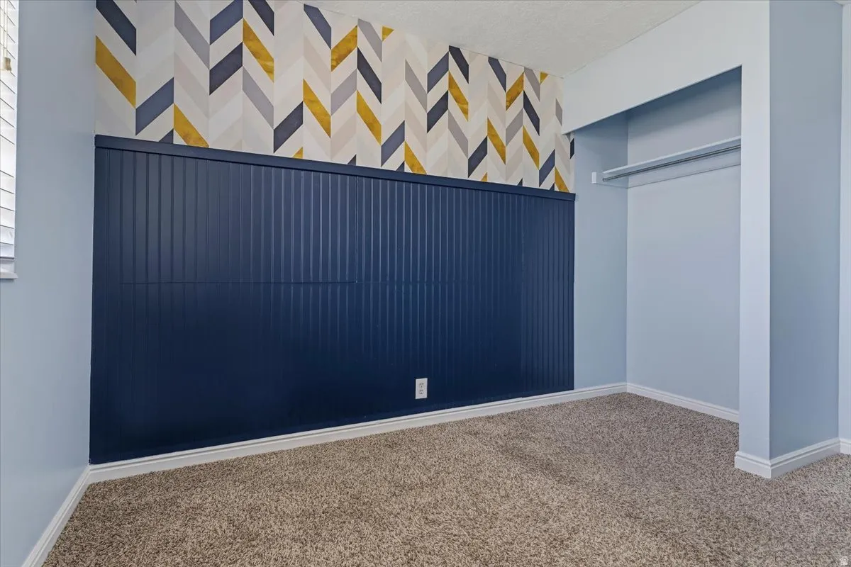 Unfurnished bedroom featuring carpet floors and a closet