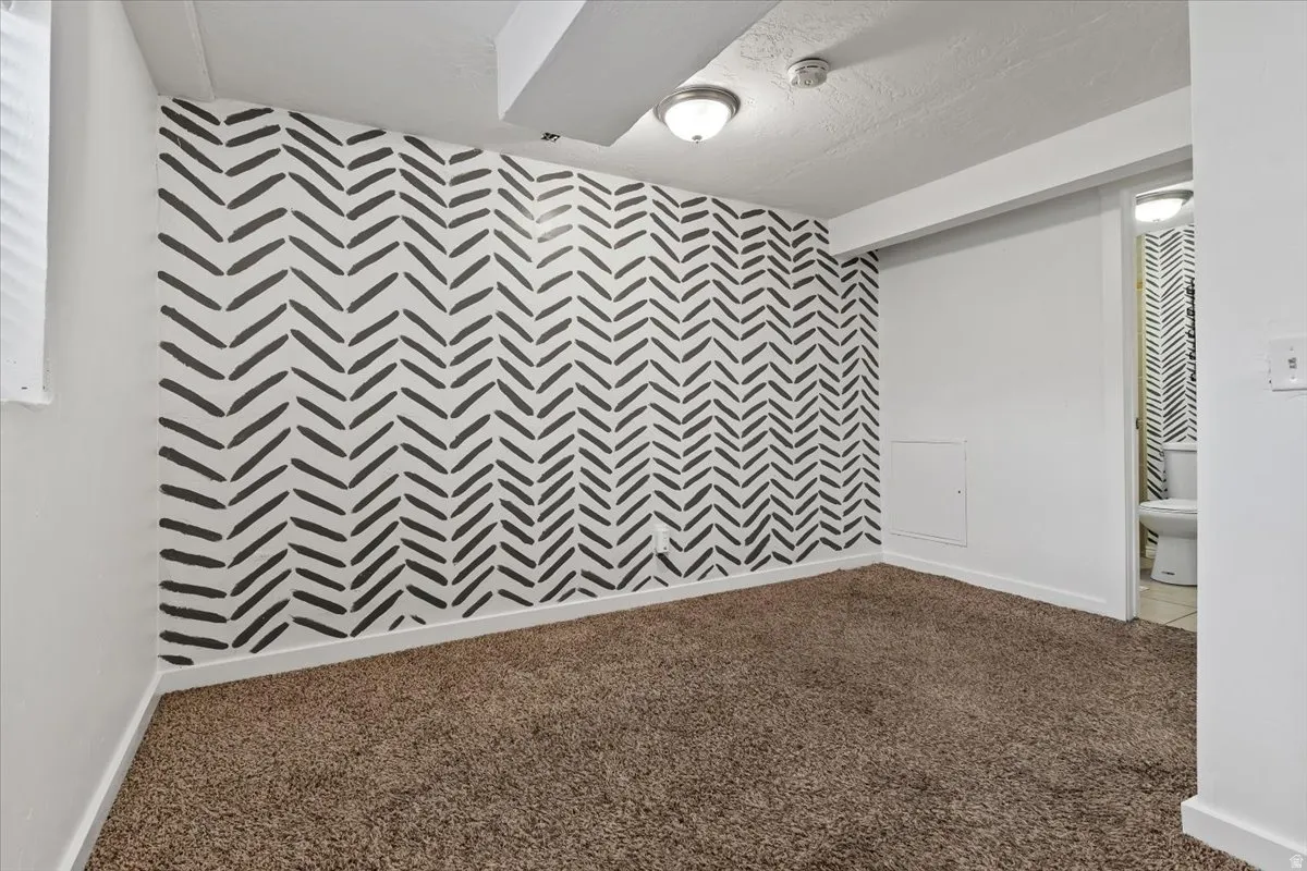 Carpeted Family Room featuring an accent wall.