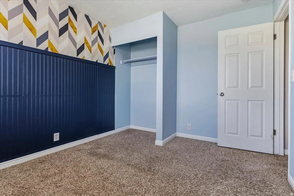 Unfurnished bedroom with carpet flooring and a closet