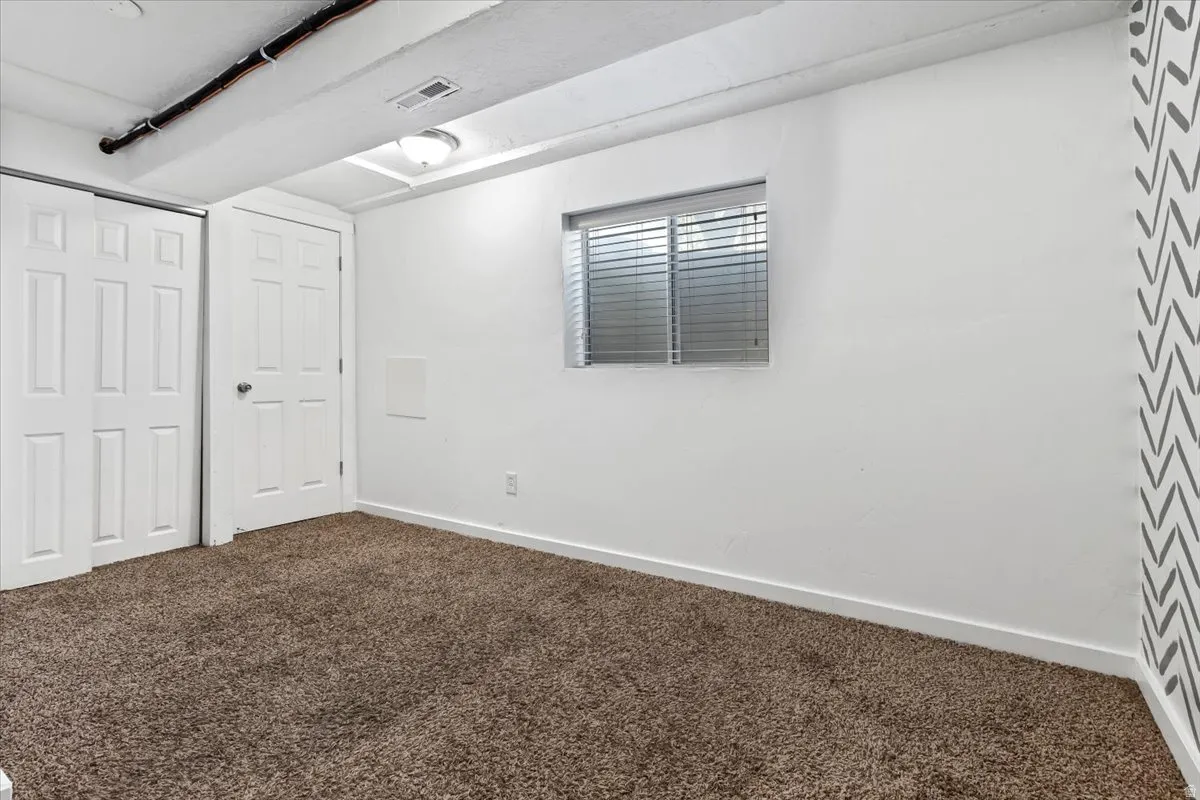 Unfurnished Family Room  featuring dark carpet and a closet