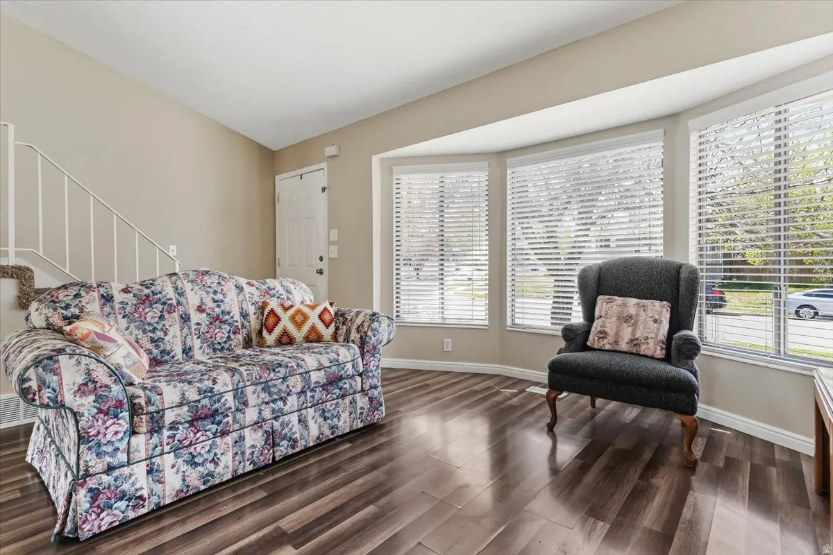 Living room featuring stairway and dark wood-style flooring