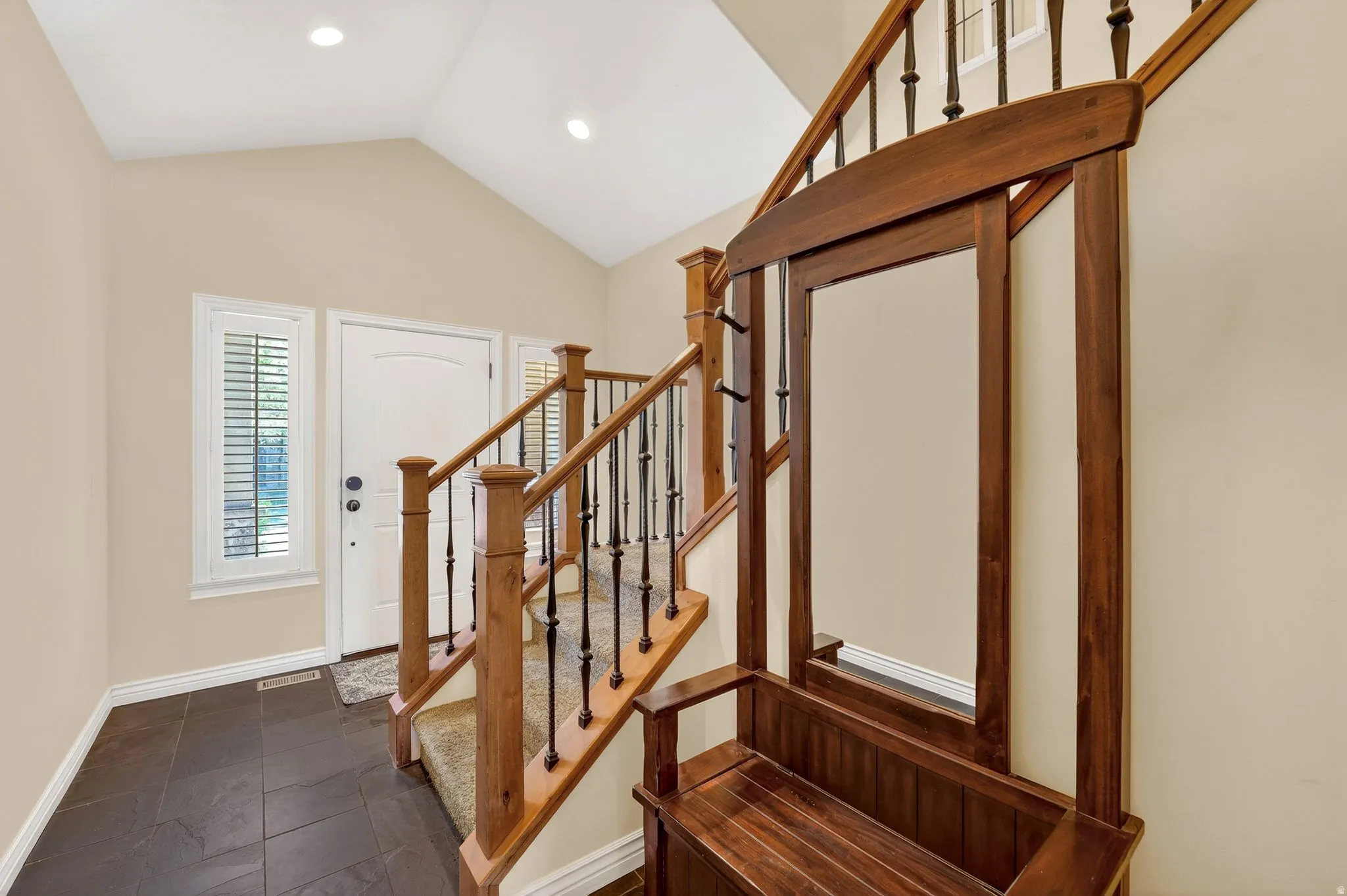 Foyer featuring vaulted ceiling and recessed lighting