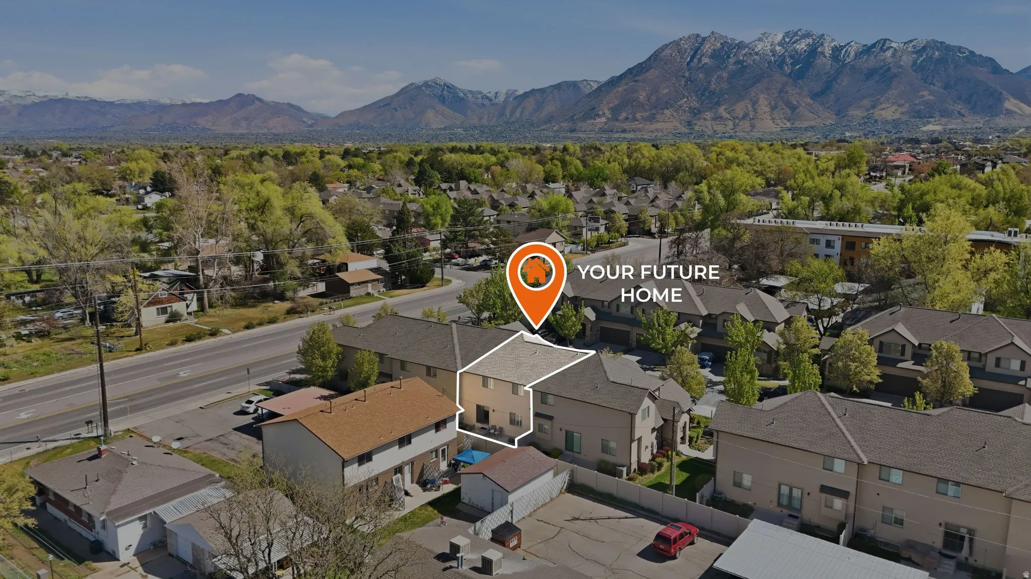 Aerial perspective of suburban area with a mountainous background