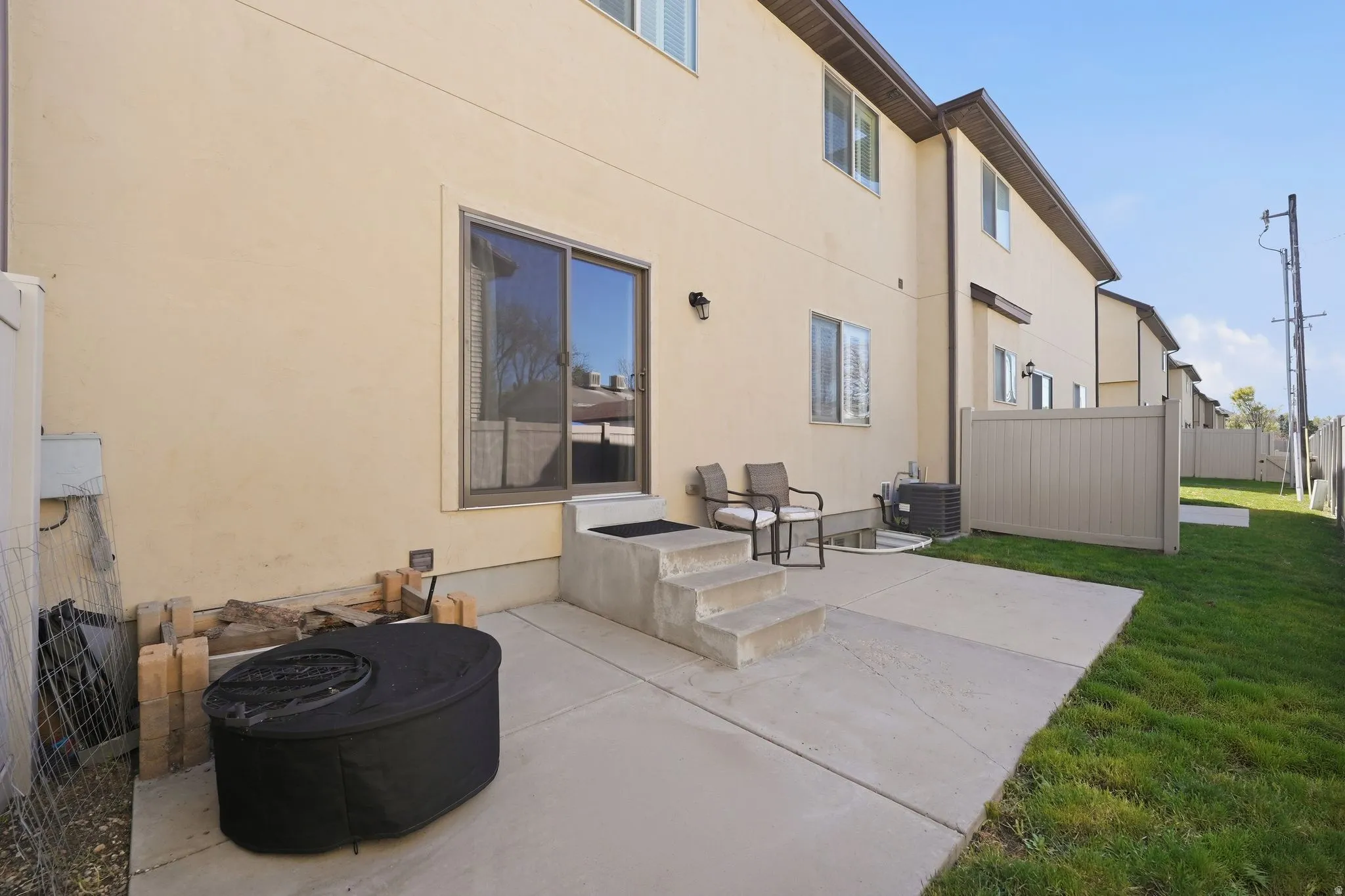 Rear view of house with a patio area and stucco siding