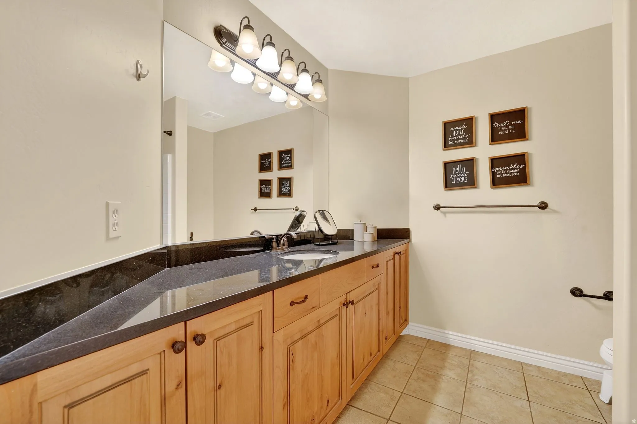 Bathroom with vanity and light tile patterned flooring