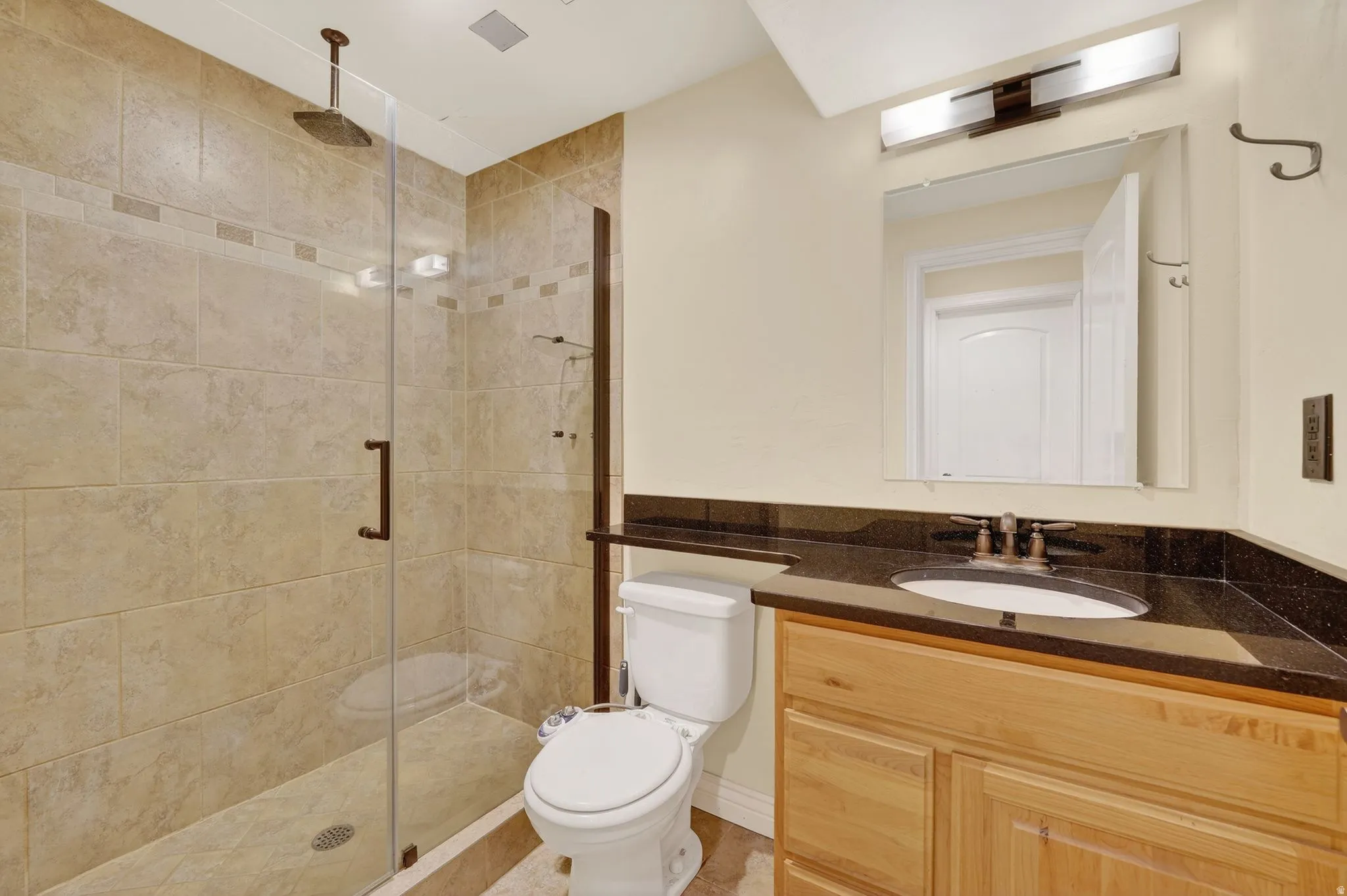 Full bath with vanity and a stall shower