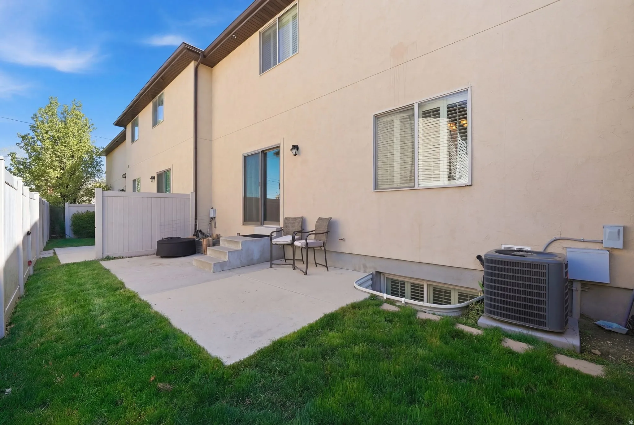 Rear view of property with stucco siding and a patio area