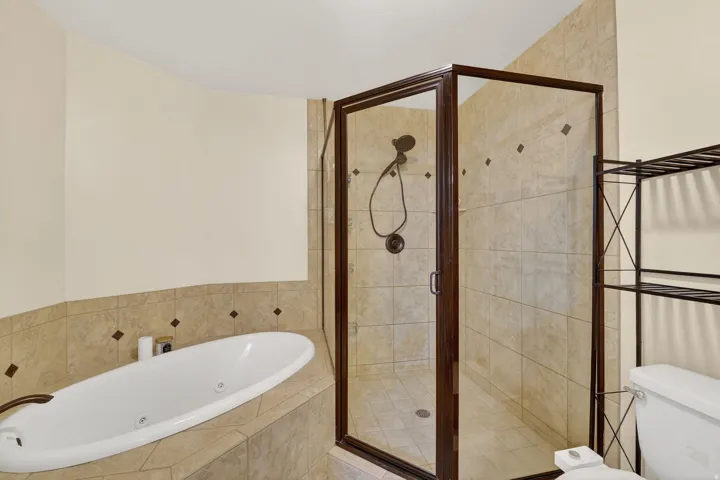 Bathroom with a jetted tub and a stall shower