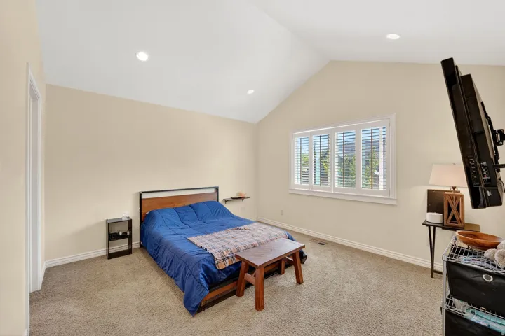 Carpeted bedroom featuring baseboards and recessed lighting