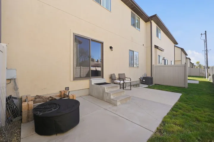 Rear view of house with a patio area and stucco siding