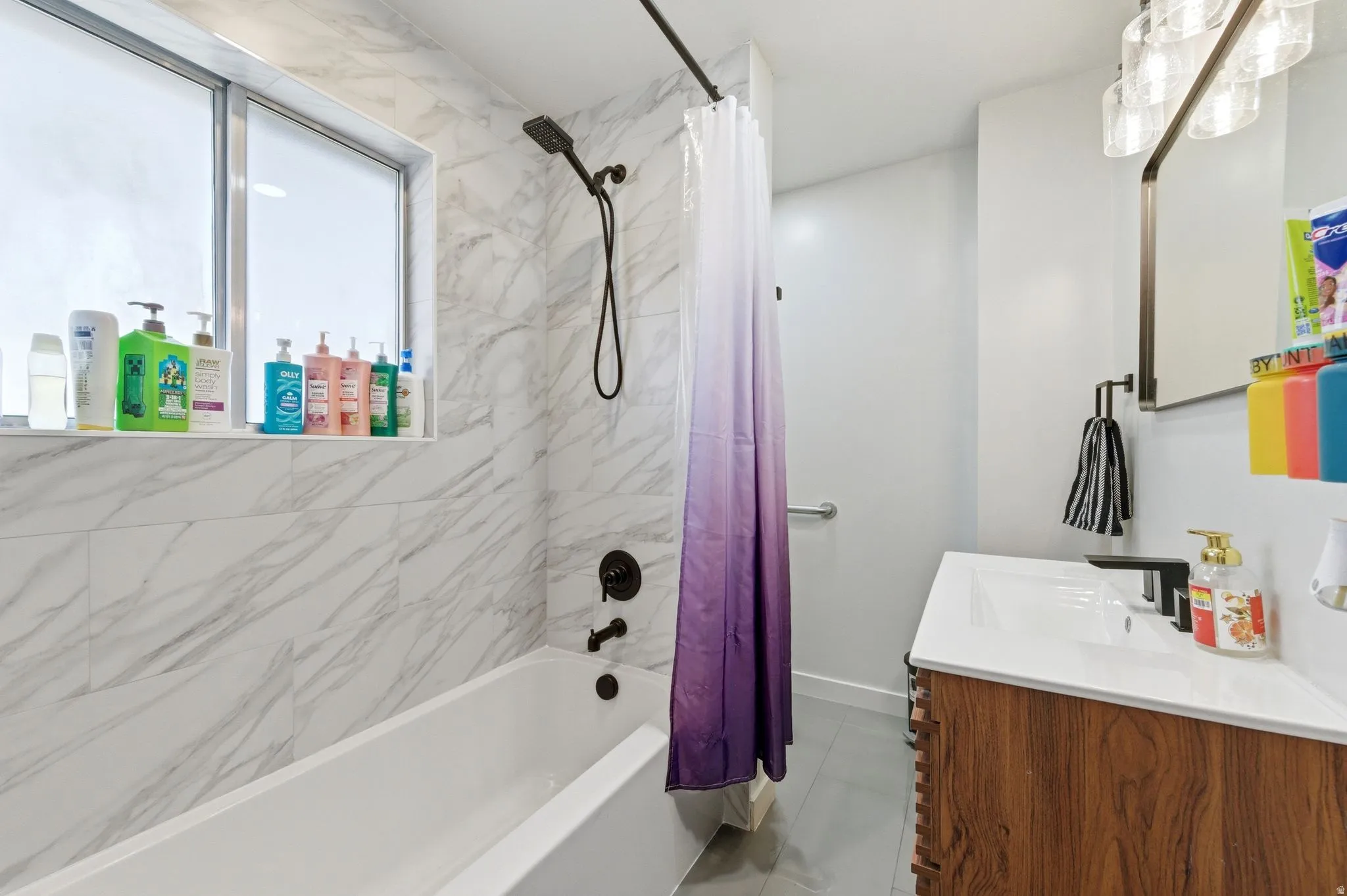 Bathroom with vanity and shower / bath combination with curtain
