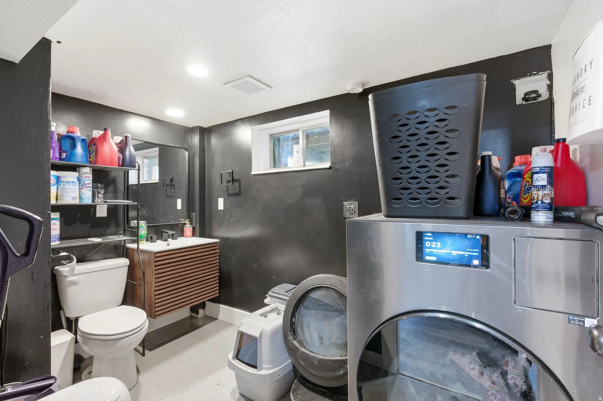 Half bathroom featuring vanity and washer / dryer