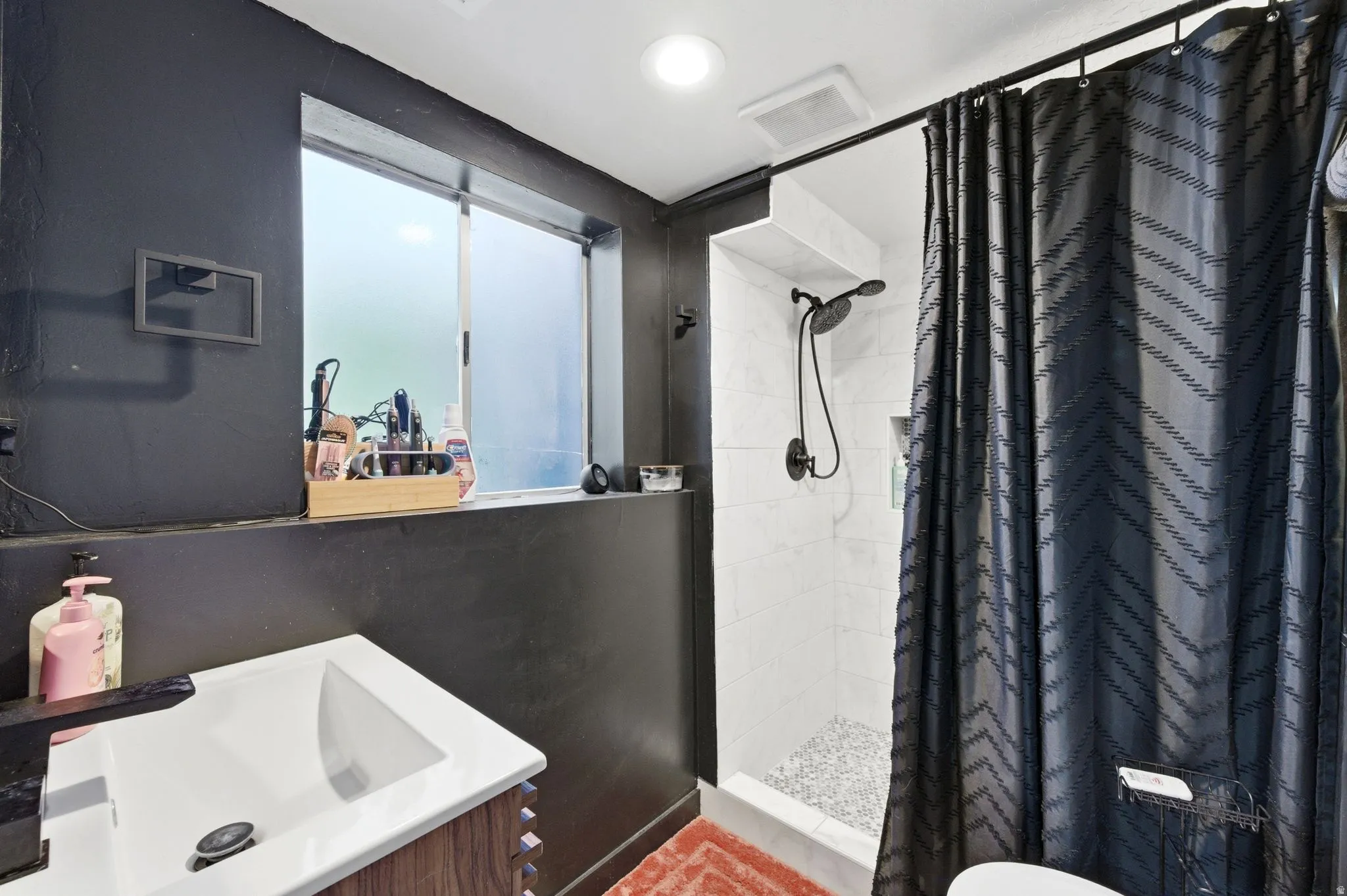 Full bath featuring vanity, a shower stall, and recessed lighting
