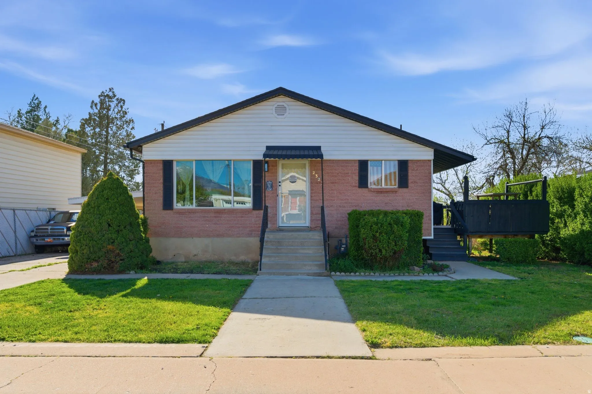 Bungalow-style home with a front yard and brick siding