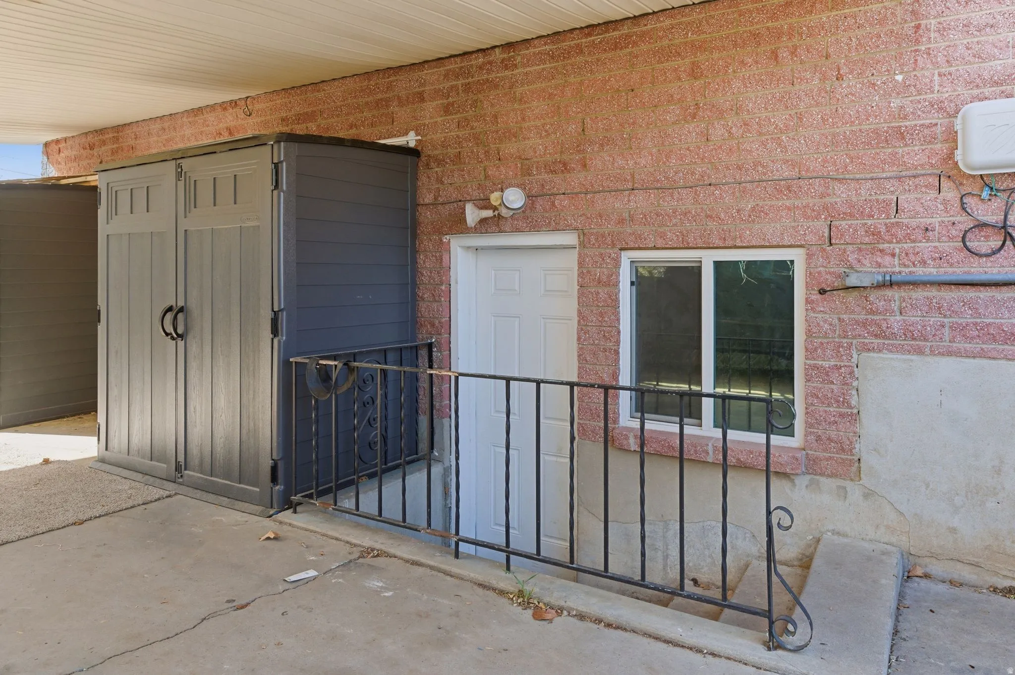 Doorway to property with brick siding