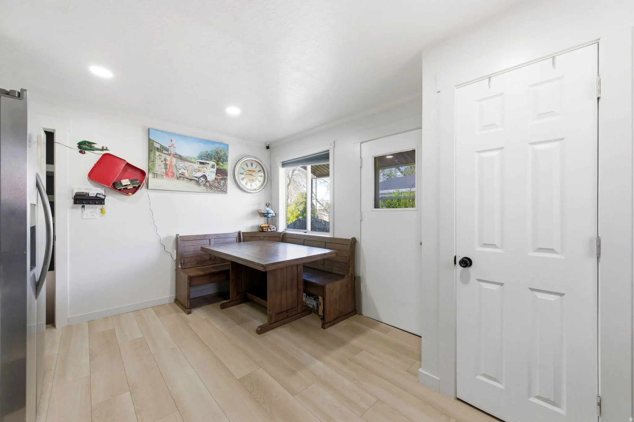 Dining area featuring light wood-type flooring and recessed lighting