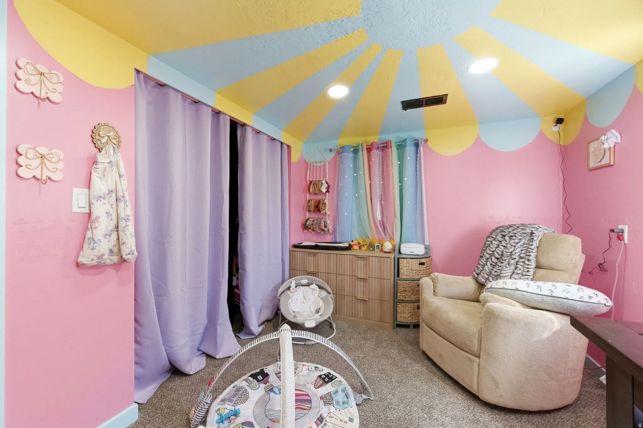 Living area with light carpet and recessed lighting