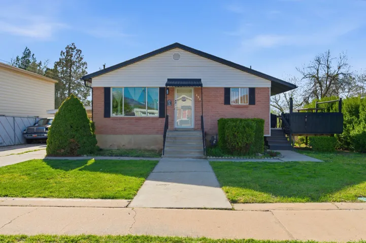 Bungalow-style home featuring brick siding and a front yard