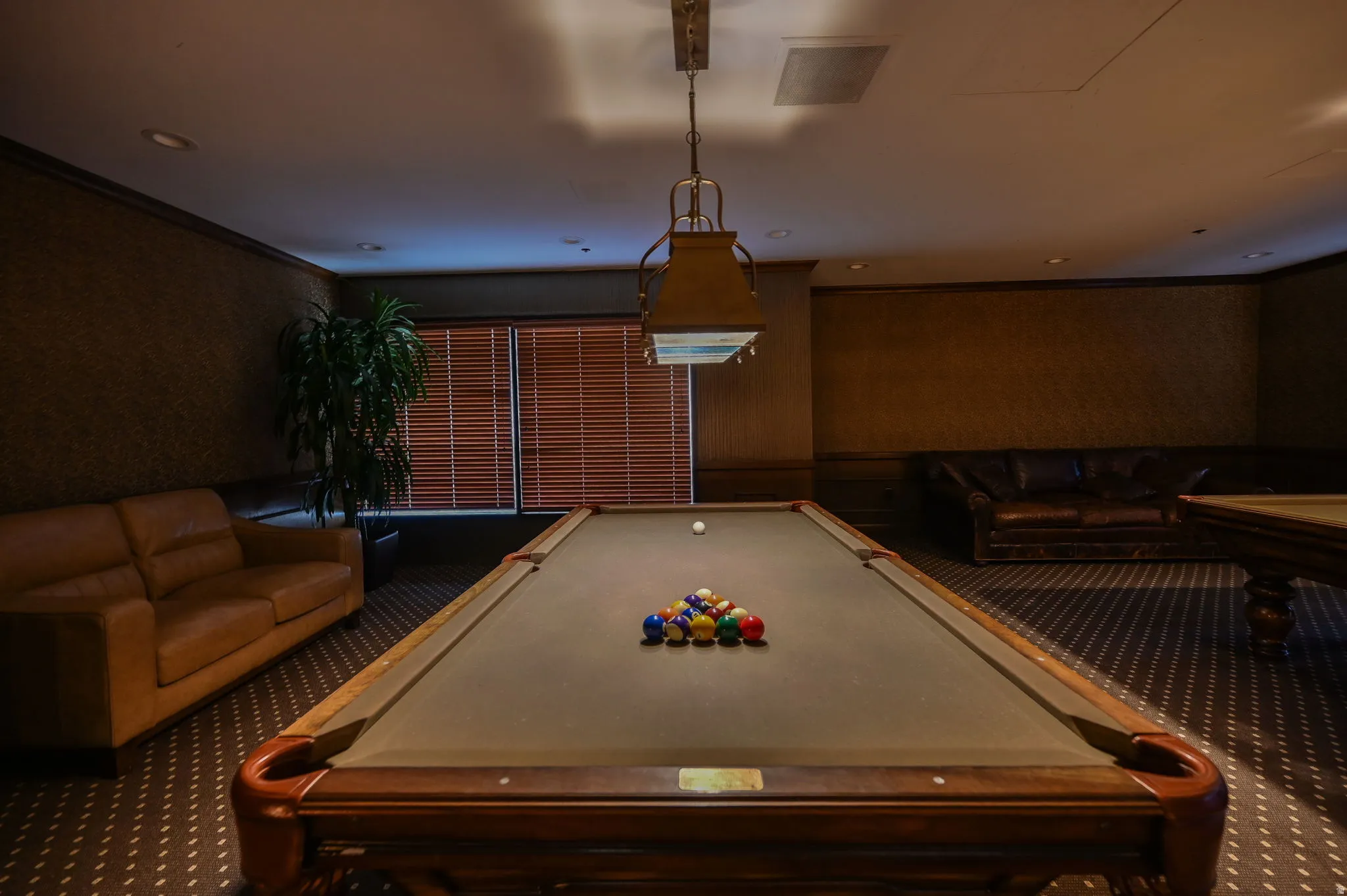 Community recreation room with pool tables, tv's and seating for entertaining.