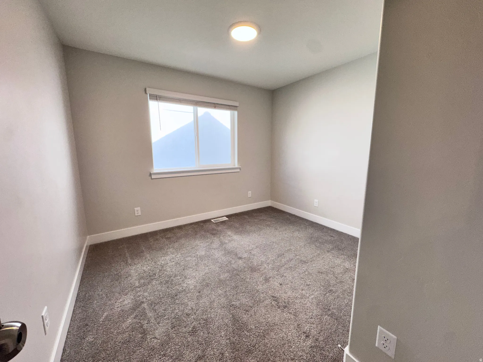 Spare room with carpet floors and baseboards