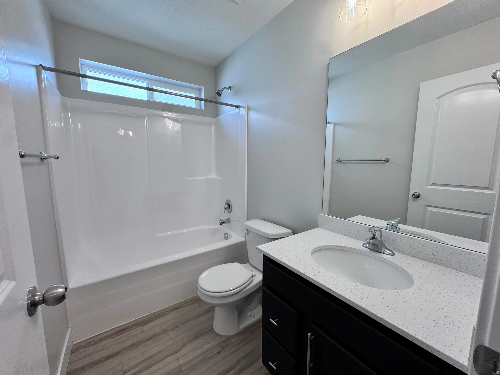 Full bathroom featuring vanity, shower / washtub combination, and dark wood-style flooring