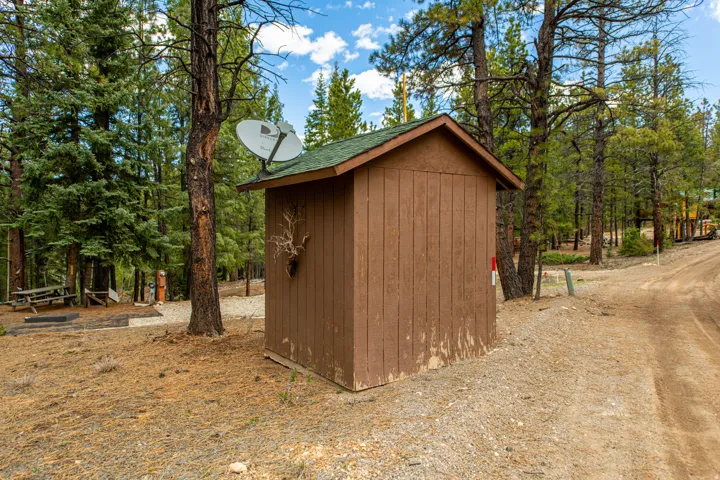 View of shed featuring view of scattered trees