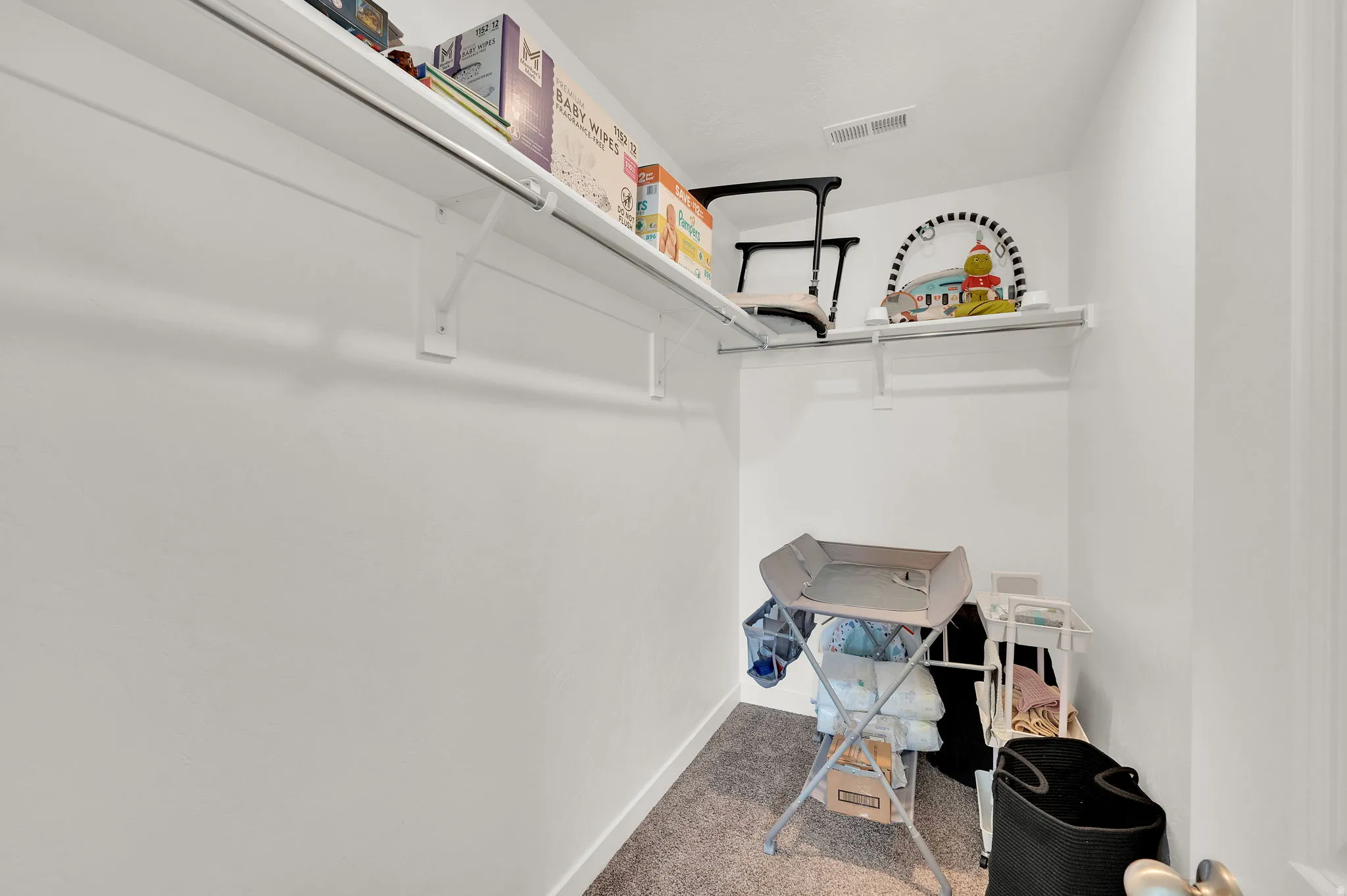 Walk in closet featuring carpet flooring