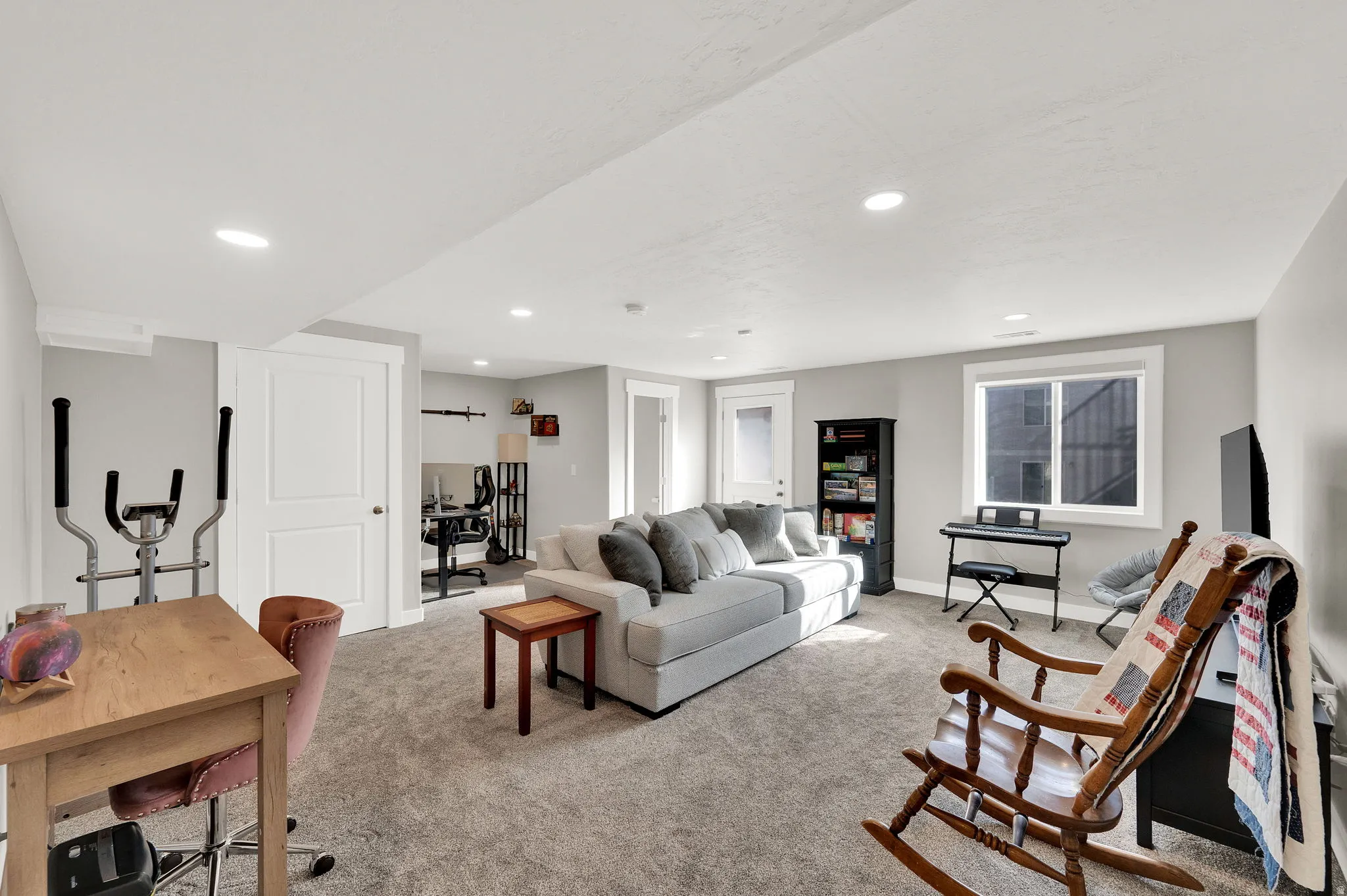 Living area featuring light colored carpet and recessed lighting