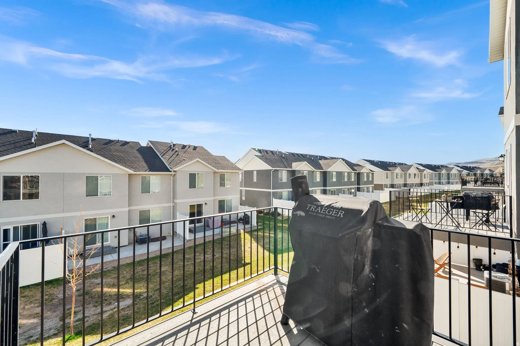 Balcony featuring a grill and a residential view