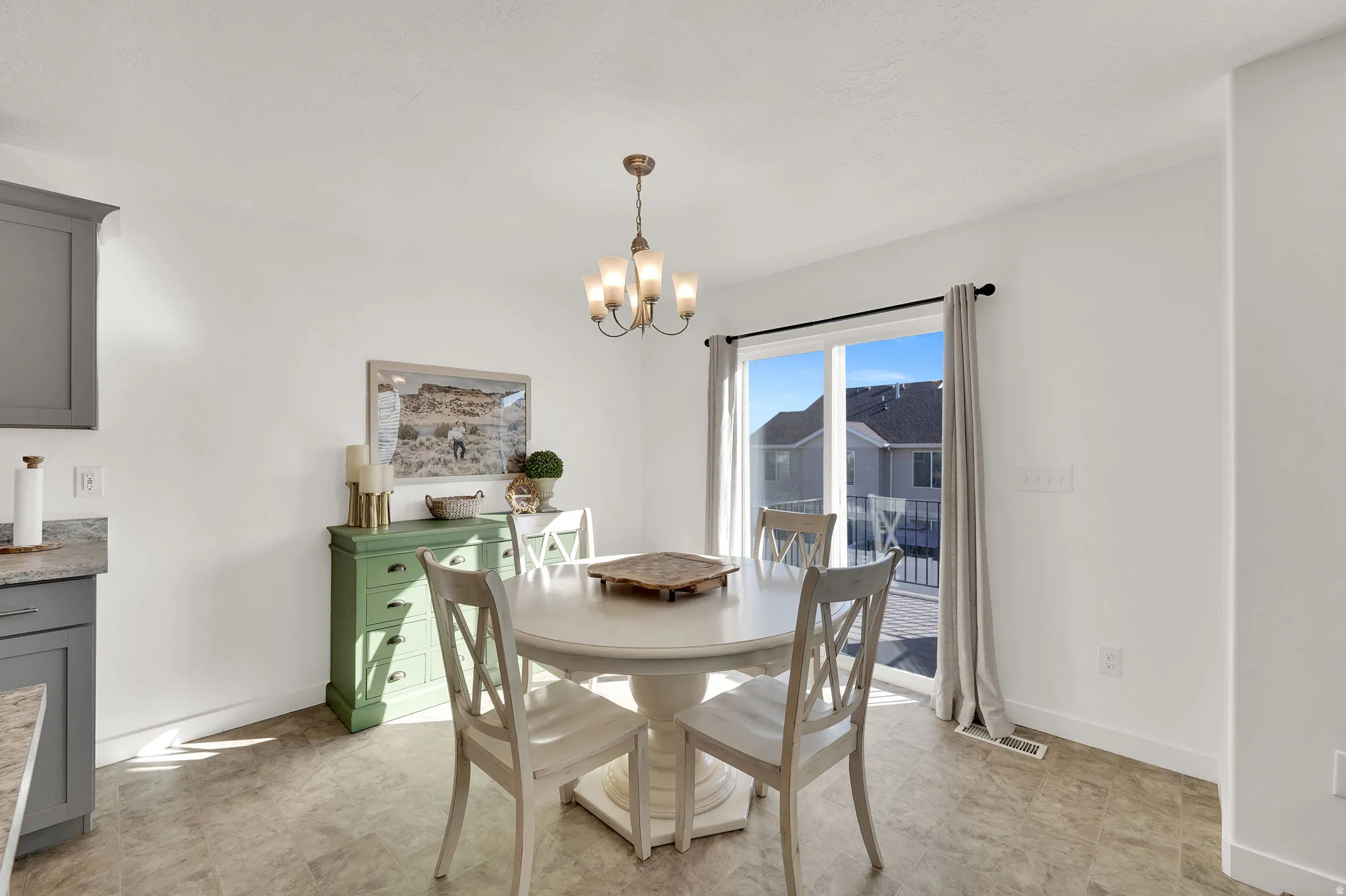 Dining space featuring baseboards and a chandelier
