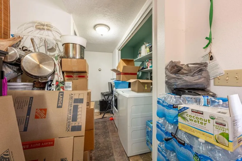 Laundry area with a textured ceiling