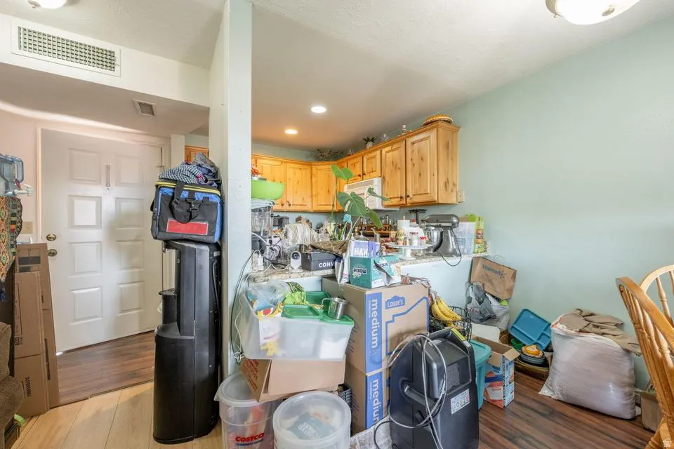 Kitchen featuring light wood-style floors, light countertops, recessed lighting, and light wood finish cabinets