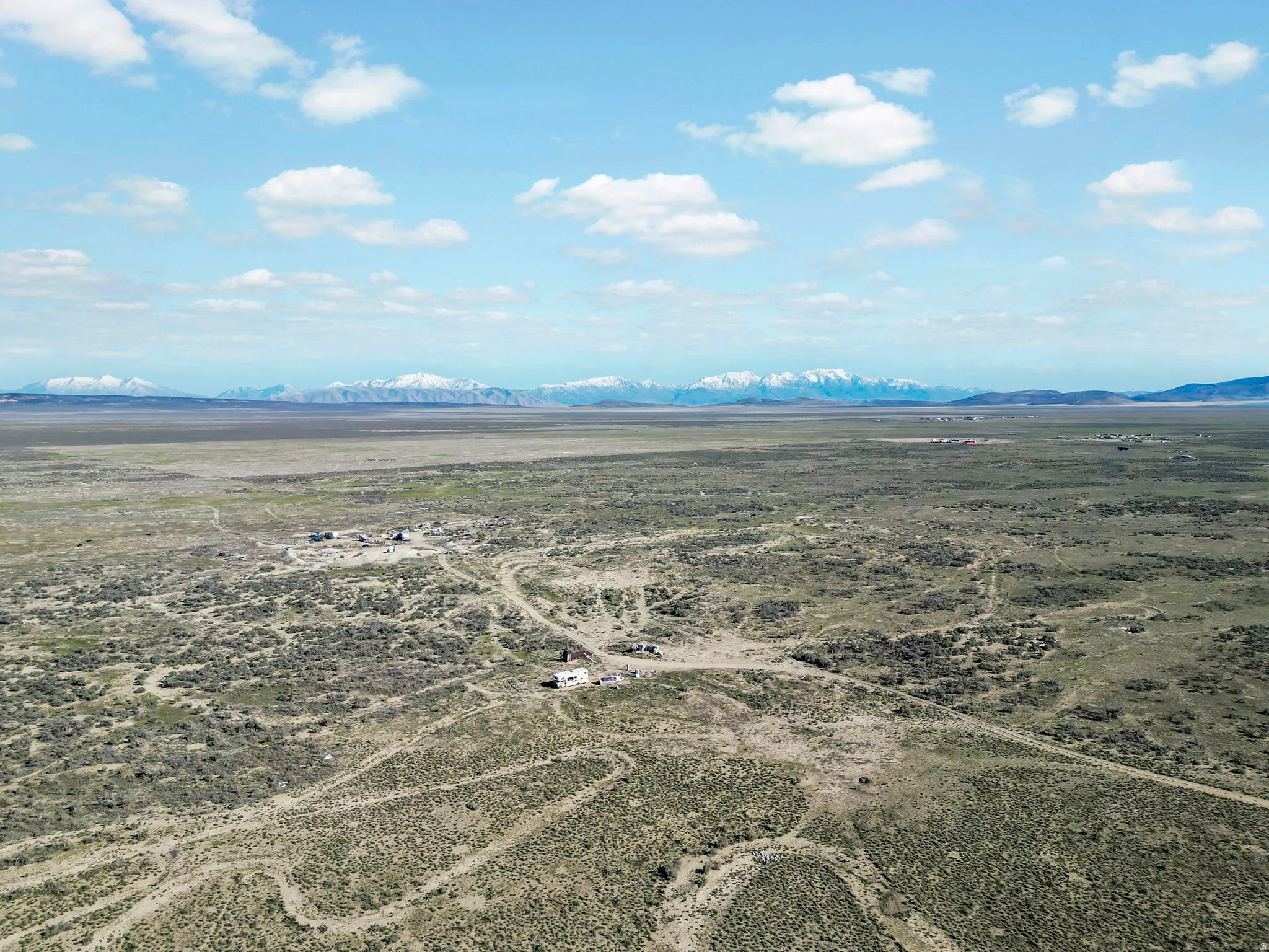 Expansive desert landscape with distant snow-capped mountains