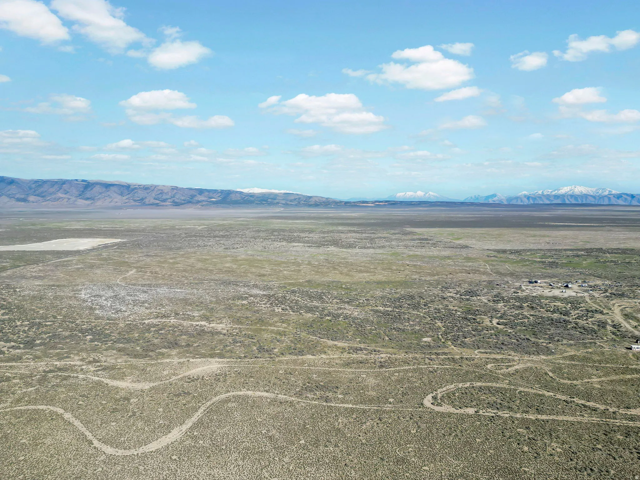 Expansive undeveloped acreage featuring natural terrain and distant mountain ranges