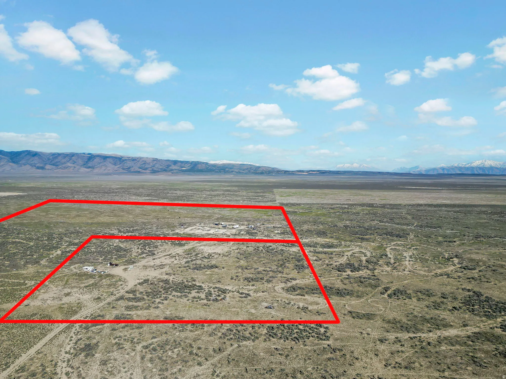 Expansive undeveloped land with a distant mountain backdrop