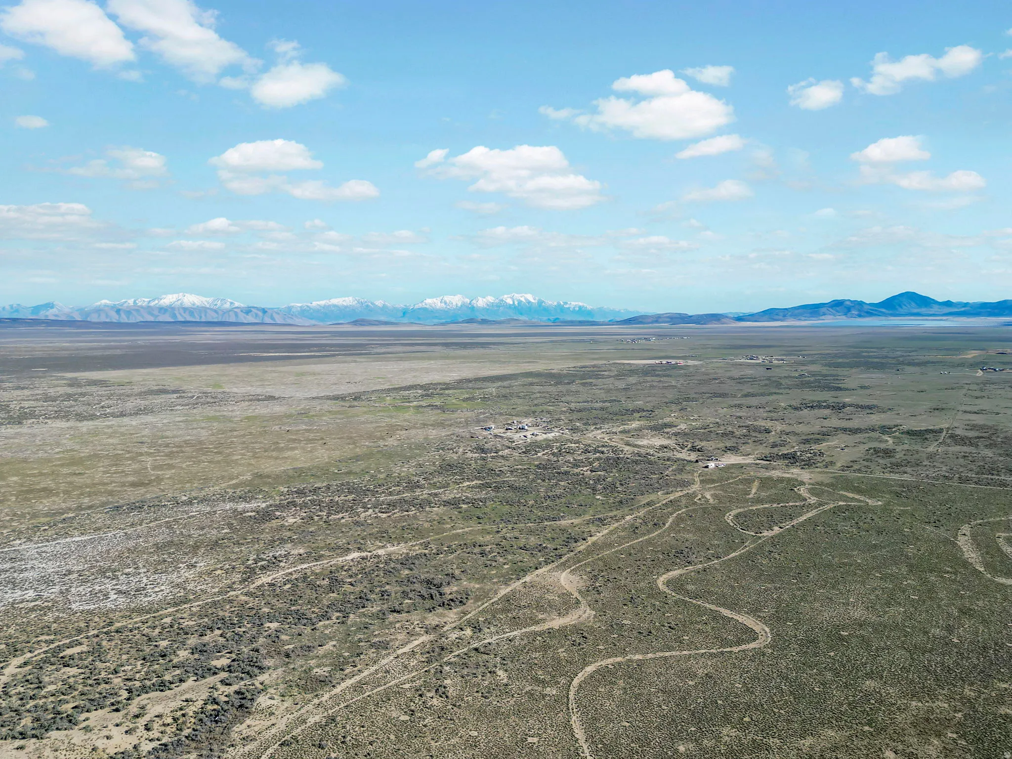 Expansive land parcel featuring natural terrain and distant mountains with snow-capped peaks