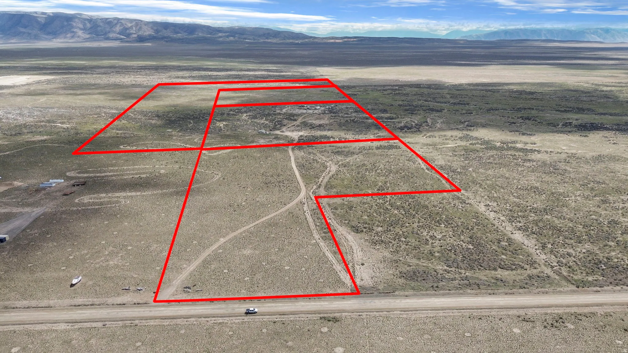 Expansive undeveloped land parcels defined by red boundary lines
