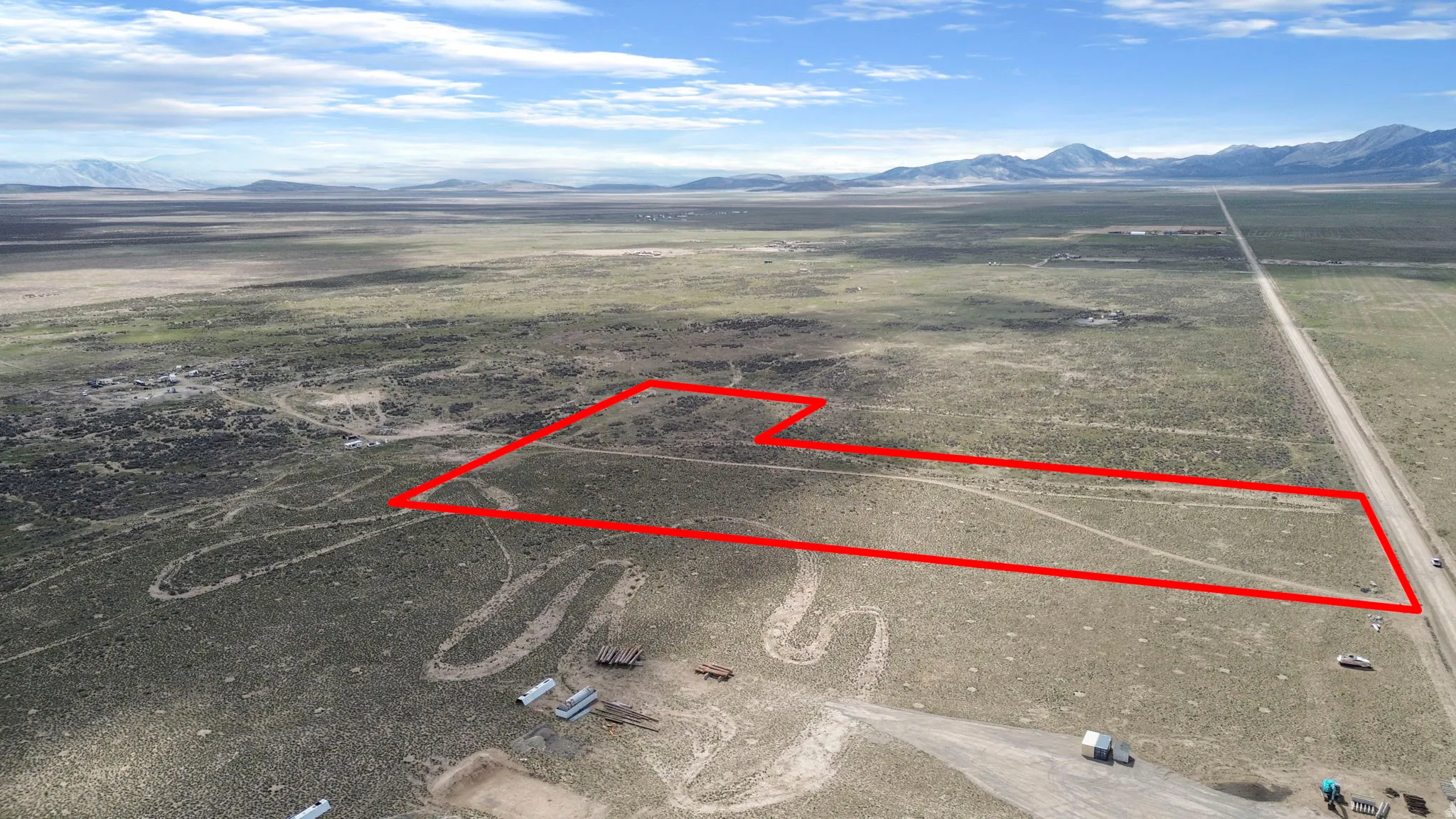 Expansive land parcel featuring natural desert vegetation, defined by a clear red boundary line