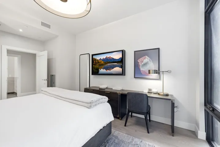Bedroom with light wood-style flooring and baseboards