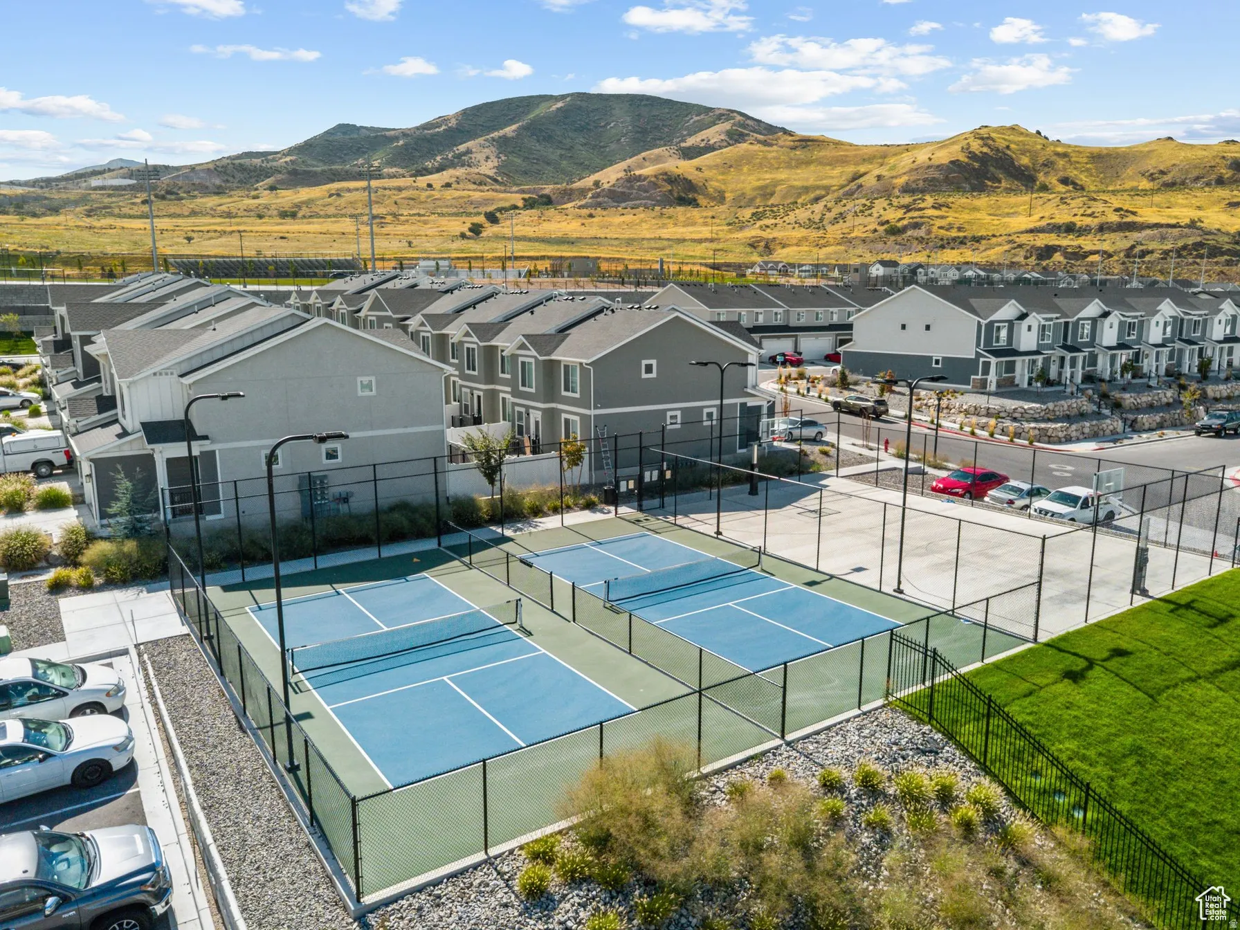 View of tennis court with a mountain view and a residential view