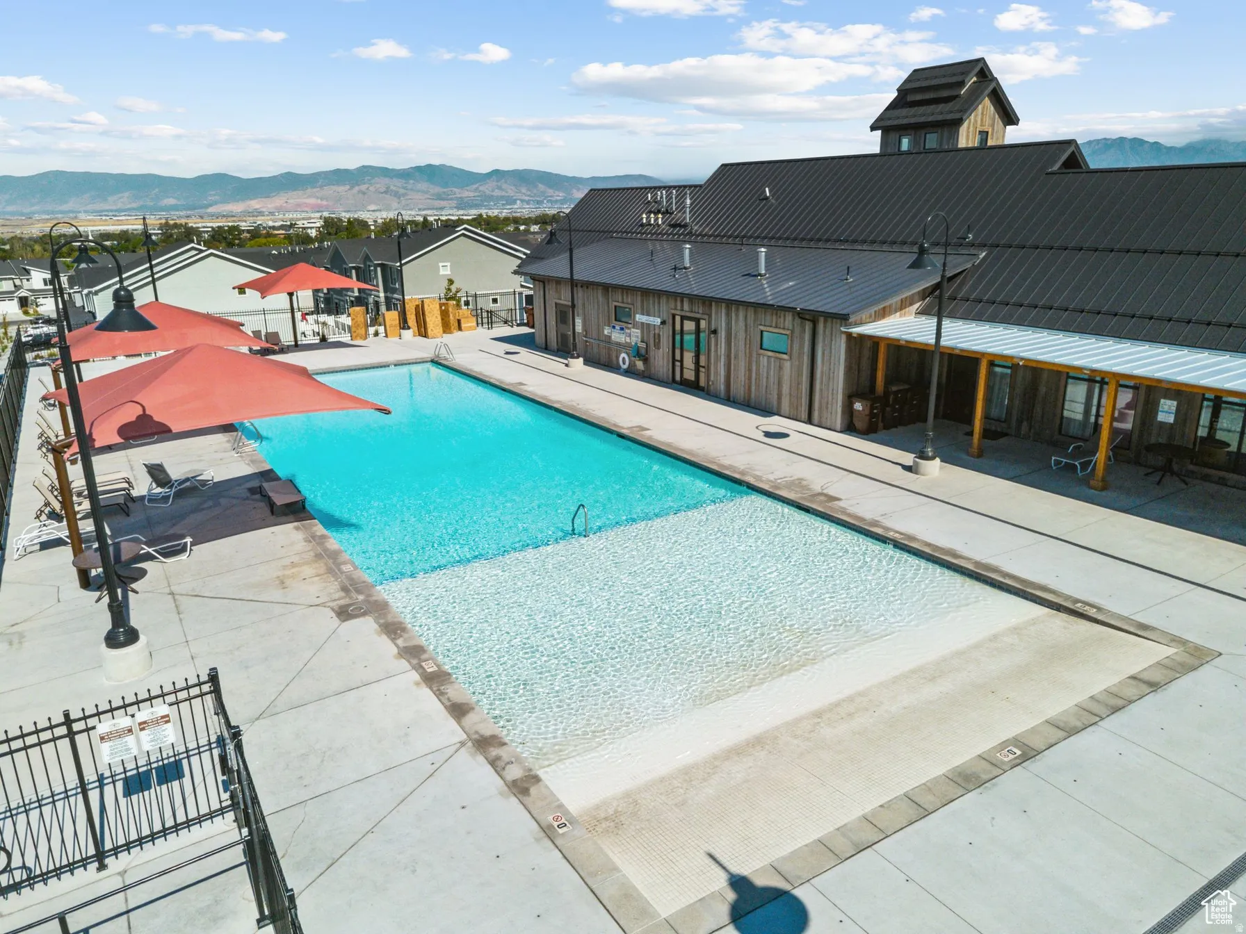 Community pool featuring a mountain view, a patio area, and a residential view