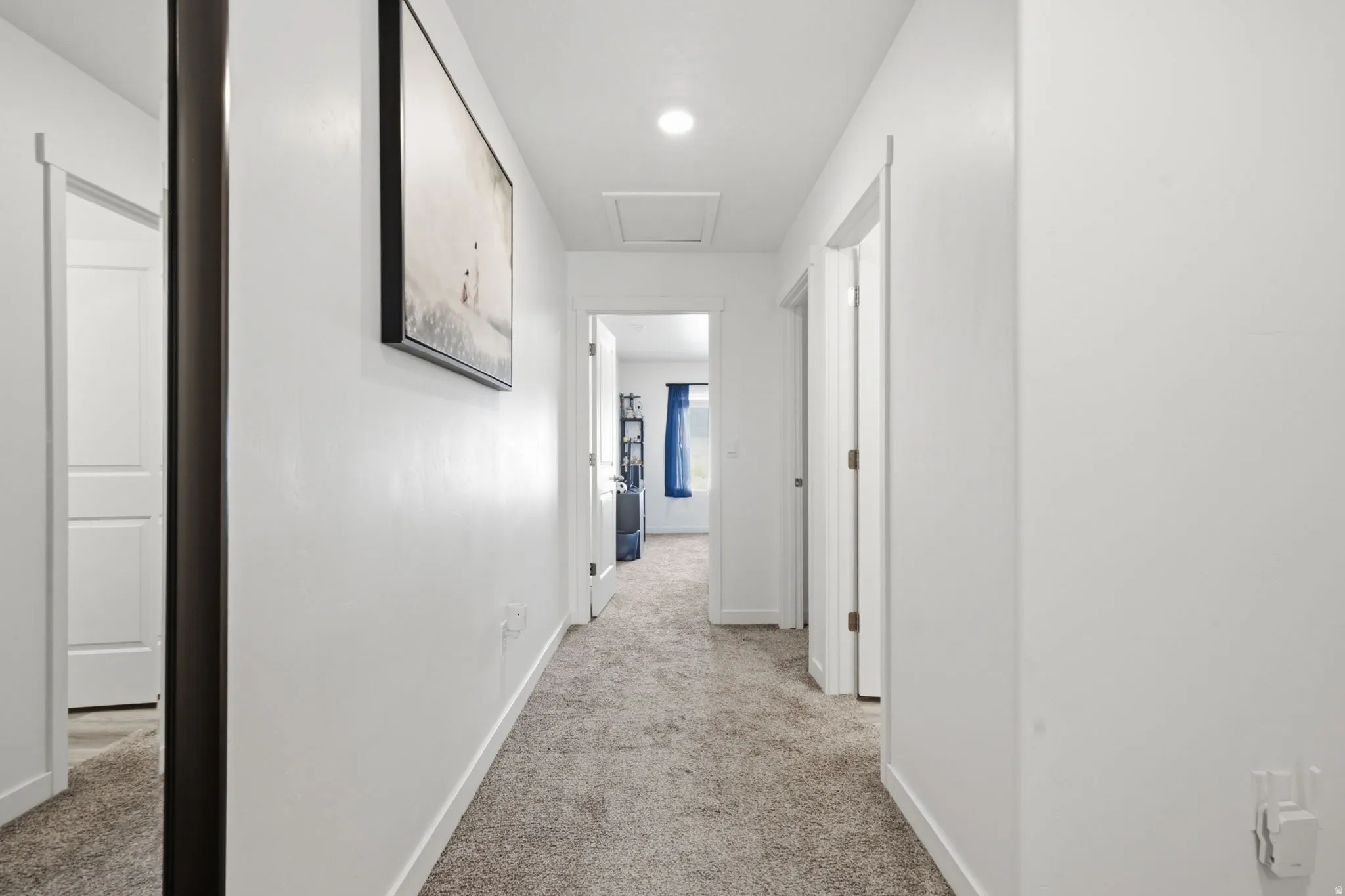 Hall featuring light colored carpet