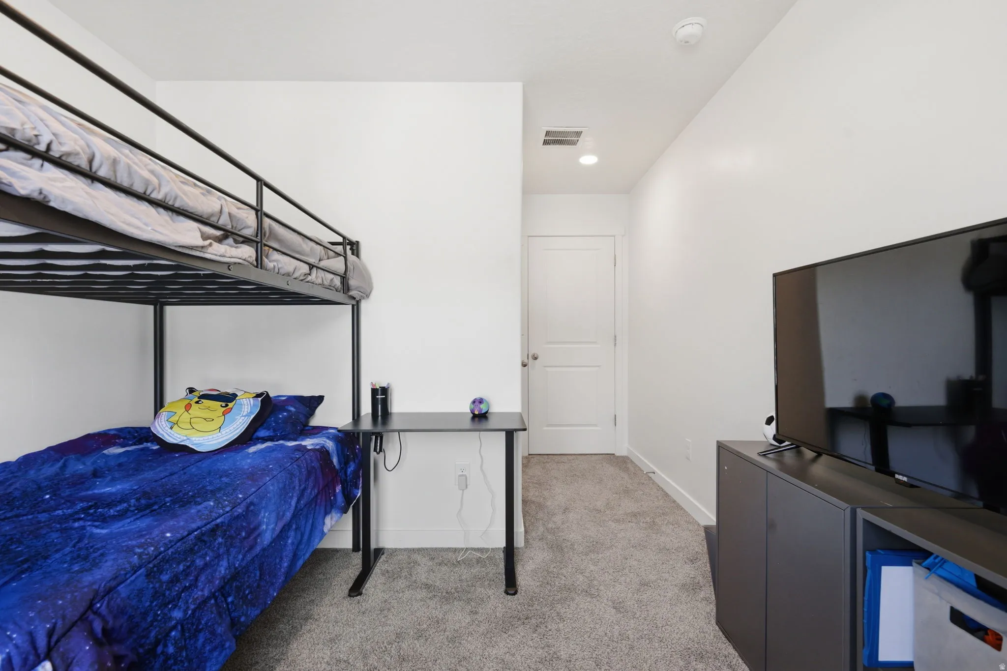 Bedroom with light carpet and baseboards