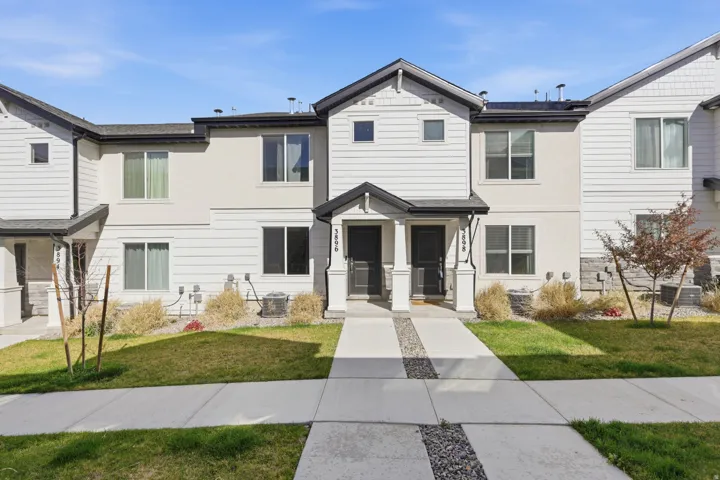 Traditional home with stucco siding and a front lawn