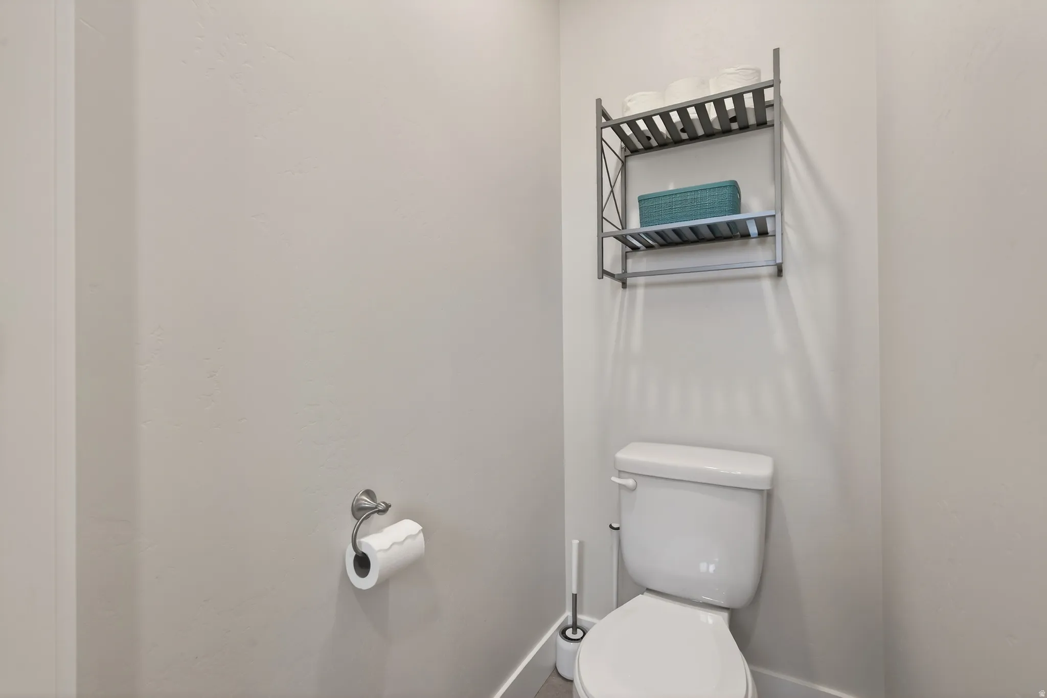 Bathroom with toilet and baseboards
