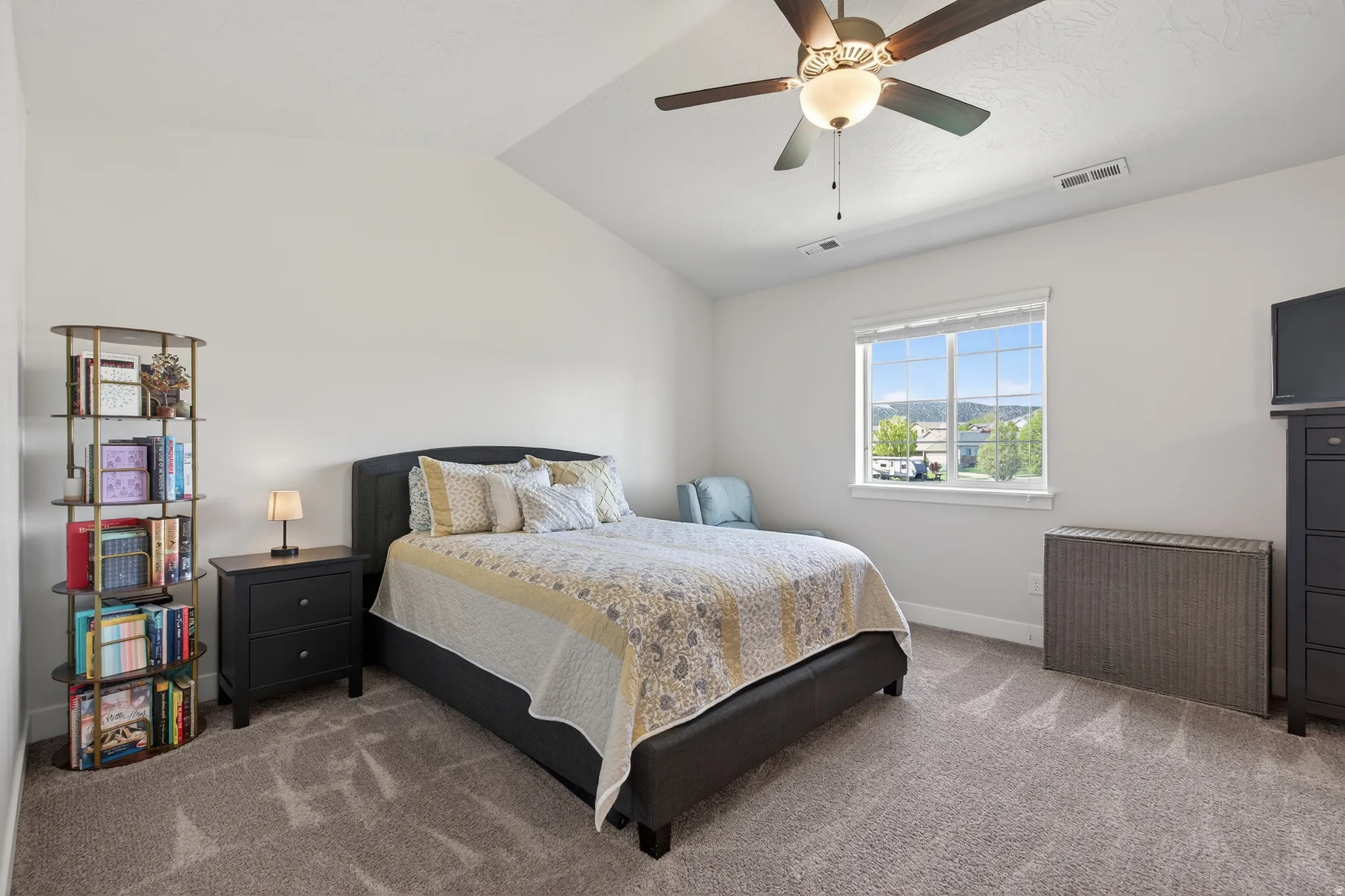 Bedroom featuring lofted ceiling, carpet floors, and ceiling fan