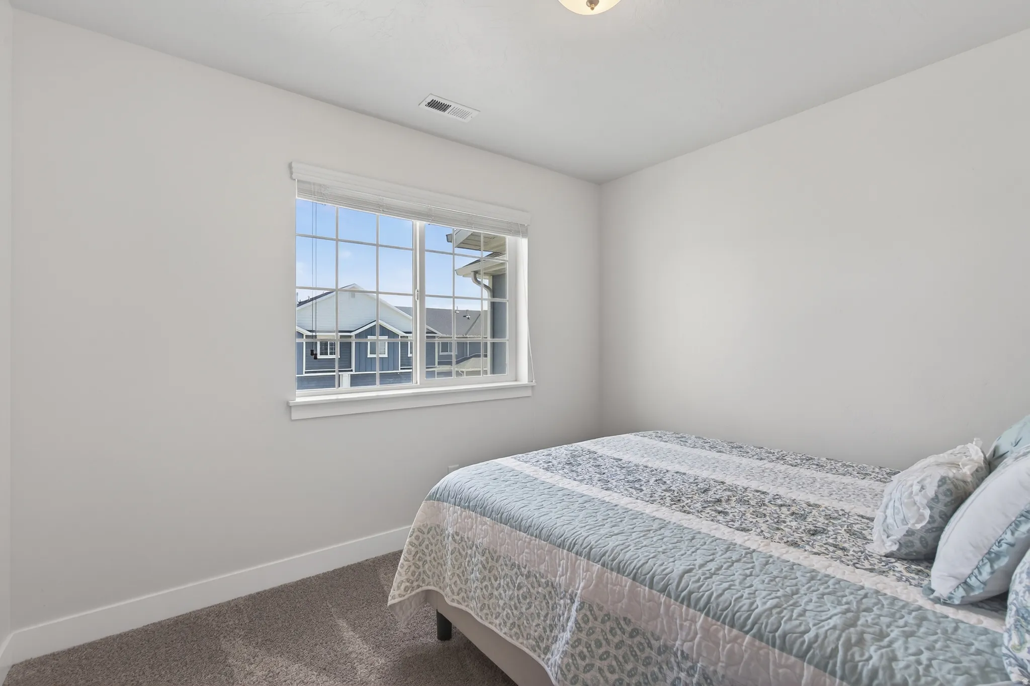 Bedroom featuring baseboards and dark carpet