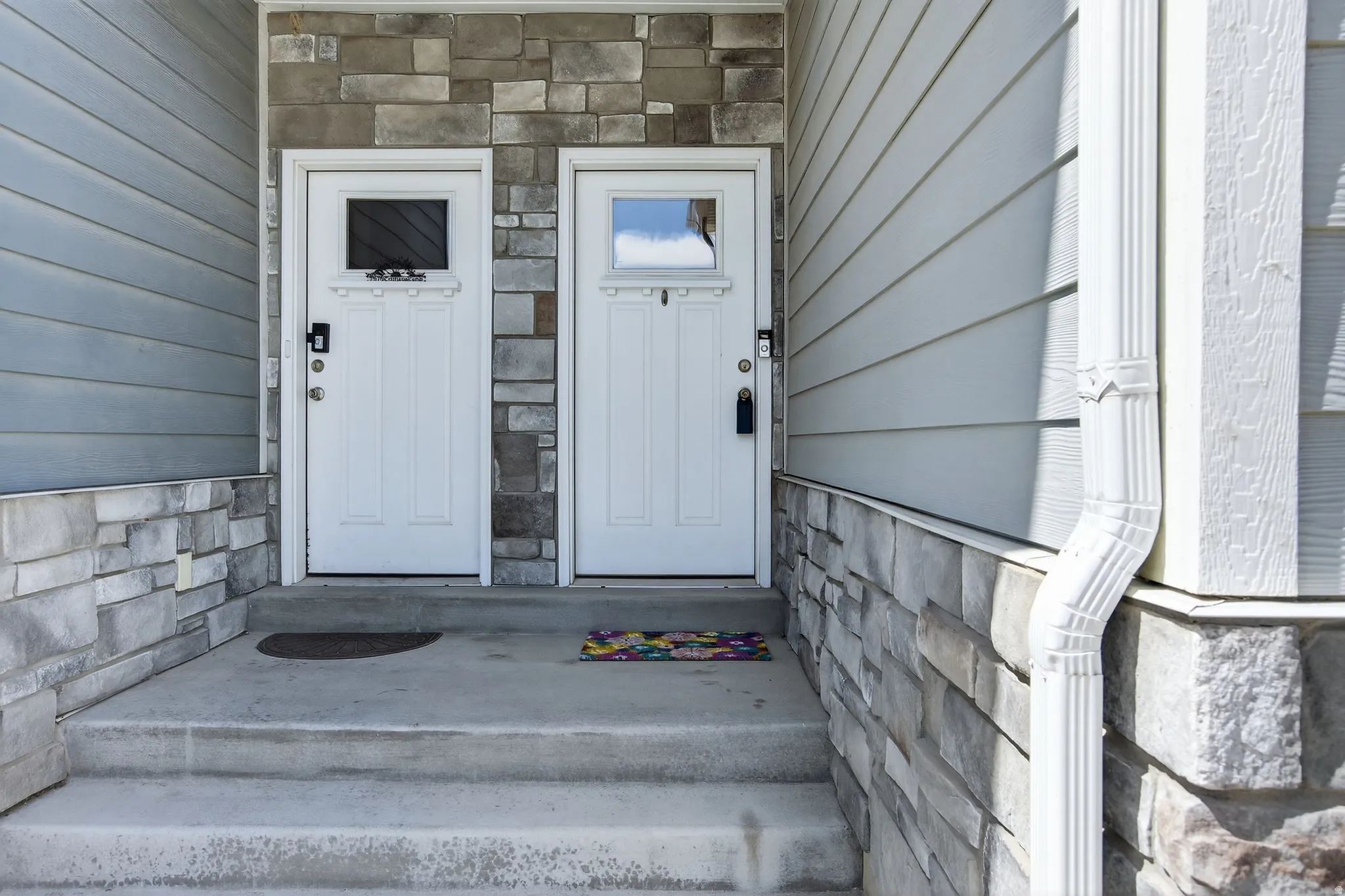 Doorway to property featuring stone siding