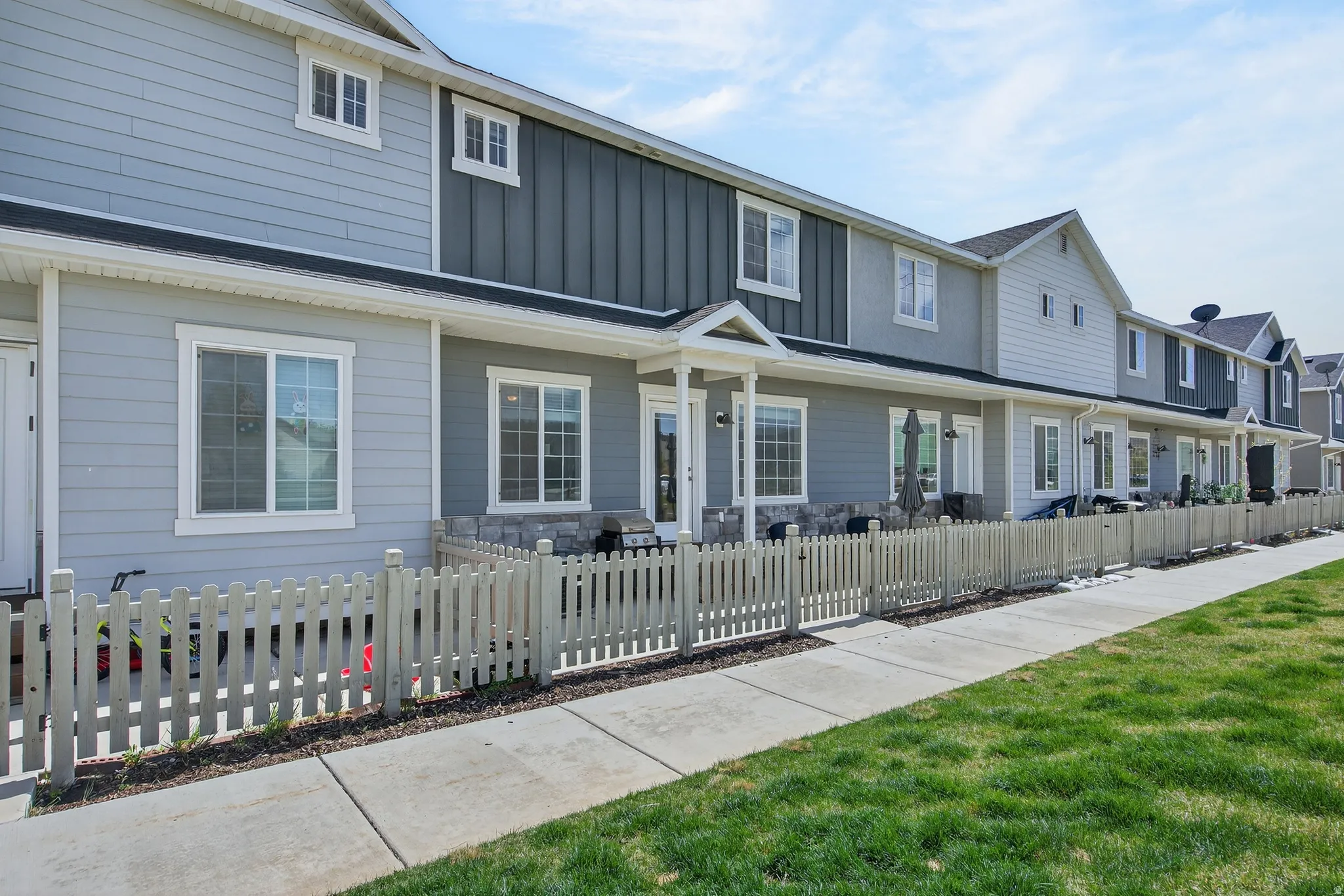 View of front of property featuring a fenced front yard, board and batten siding, and a residential view