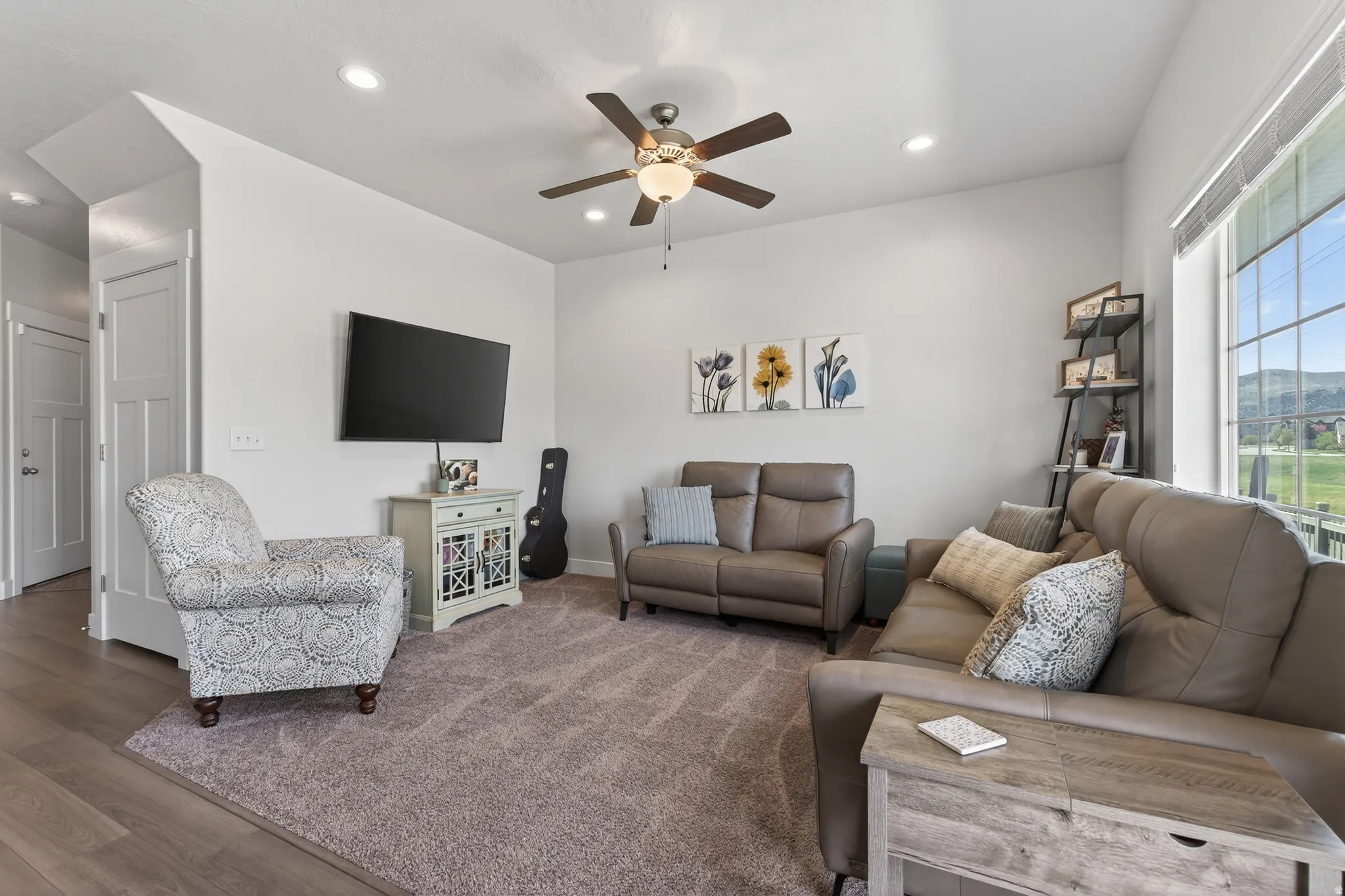 Living area with a ceiling fan, recessed lighting, and wood finished floors
